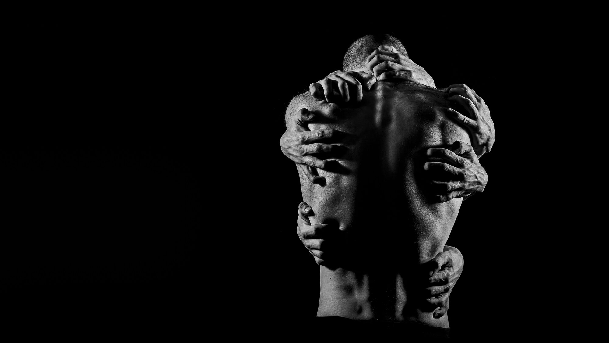 Mood still: two faces close in low light.